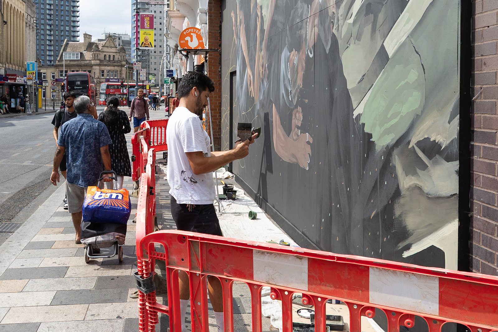 Aaron Li-Hill's artwork between Boots and Popeyes on Ilford High Road
